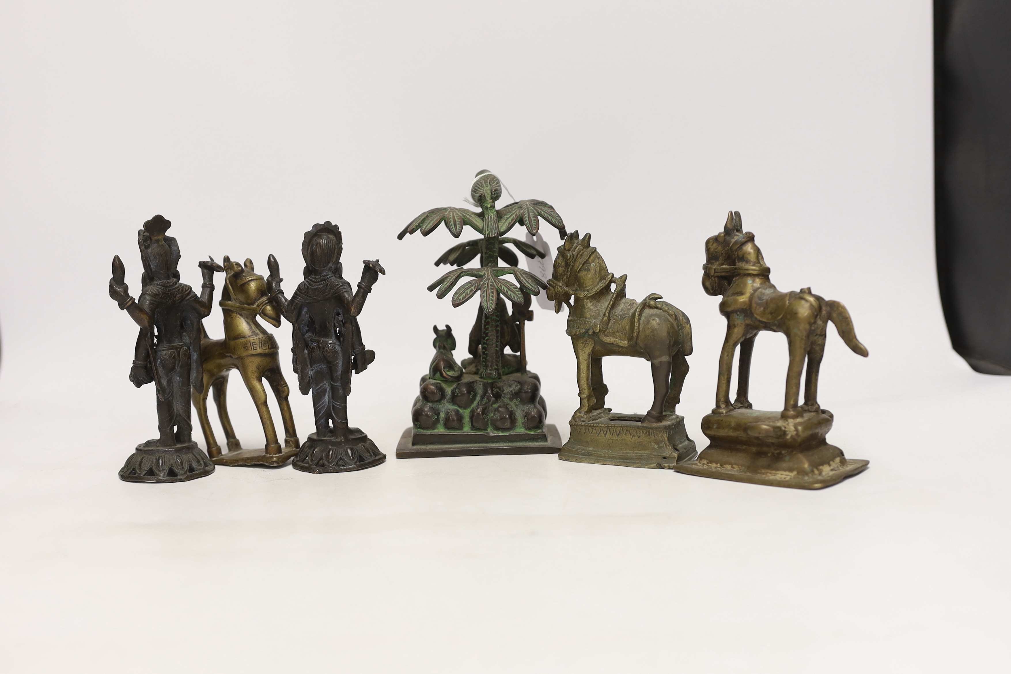 Six Indian bronze/brass ornaments; Shiva sitting under a bael tree with a bird, 17cm, two figures of Lord Vishnu and three horses